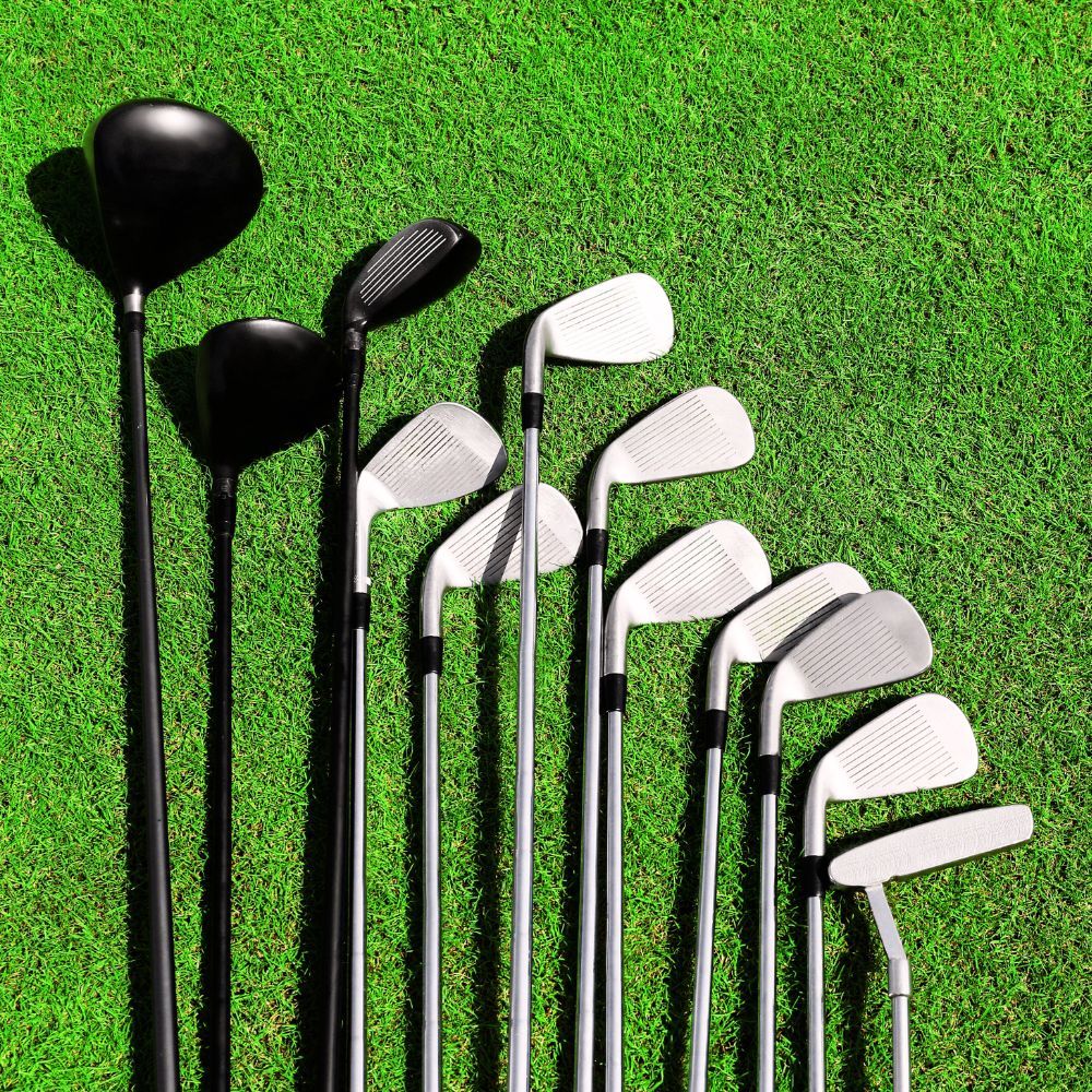 Golfers playing golf with a complete set of golf clubs
